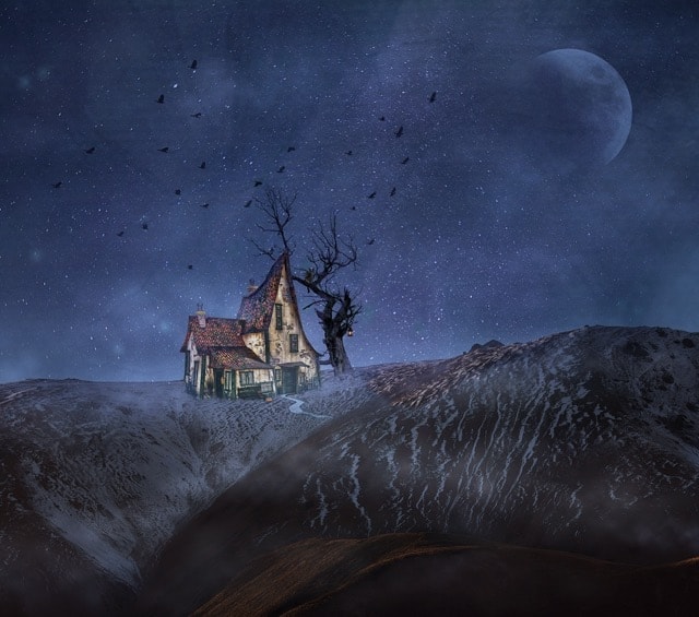 Photography ideas: A house on a hill with crows flying around it.