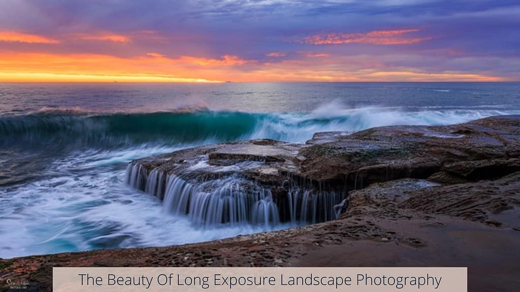 Captivating long exposure landscape photograph displaying a rocky shoreline with waves cascading into a natural pool, under a dramatic sunset sky. Text on the image reads 'The Beauty Of Long Exposure Landscape Photography', emphasizing the smooth, flowing water effect and vibrant sky achieved through this technique