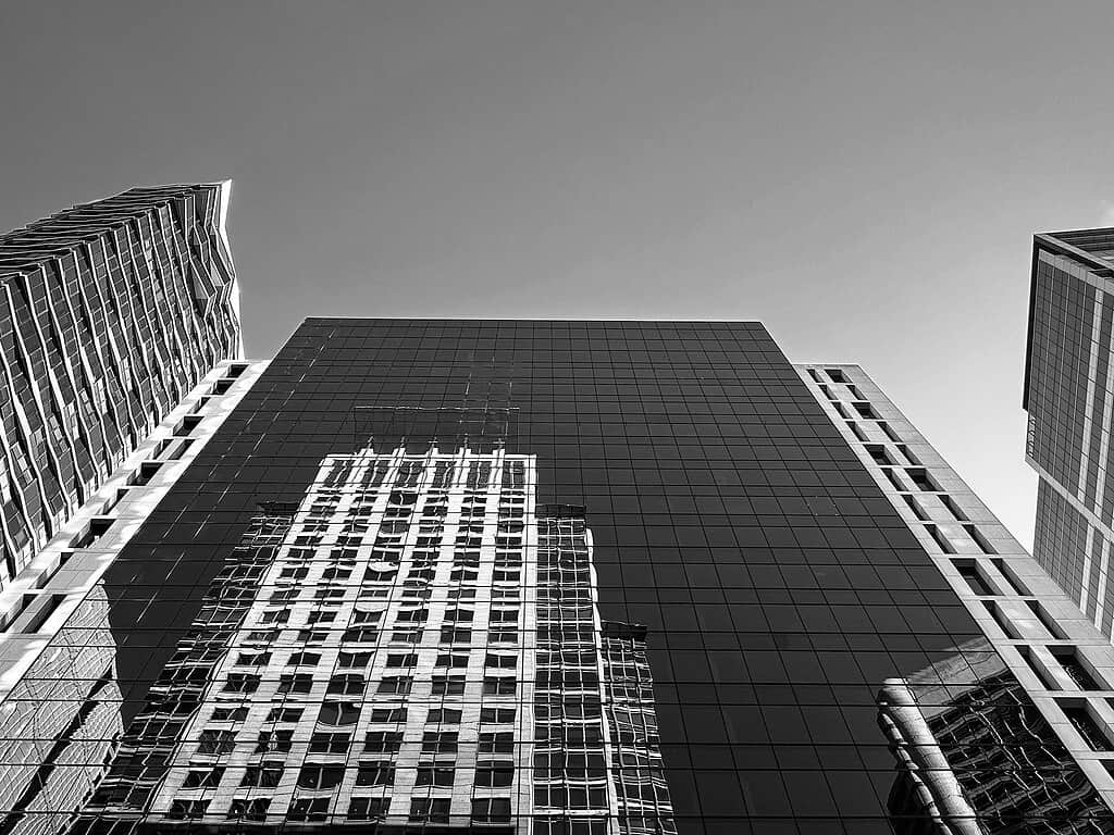 Black and white image of buildings in a city being an example of taking photos from different angles